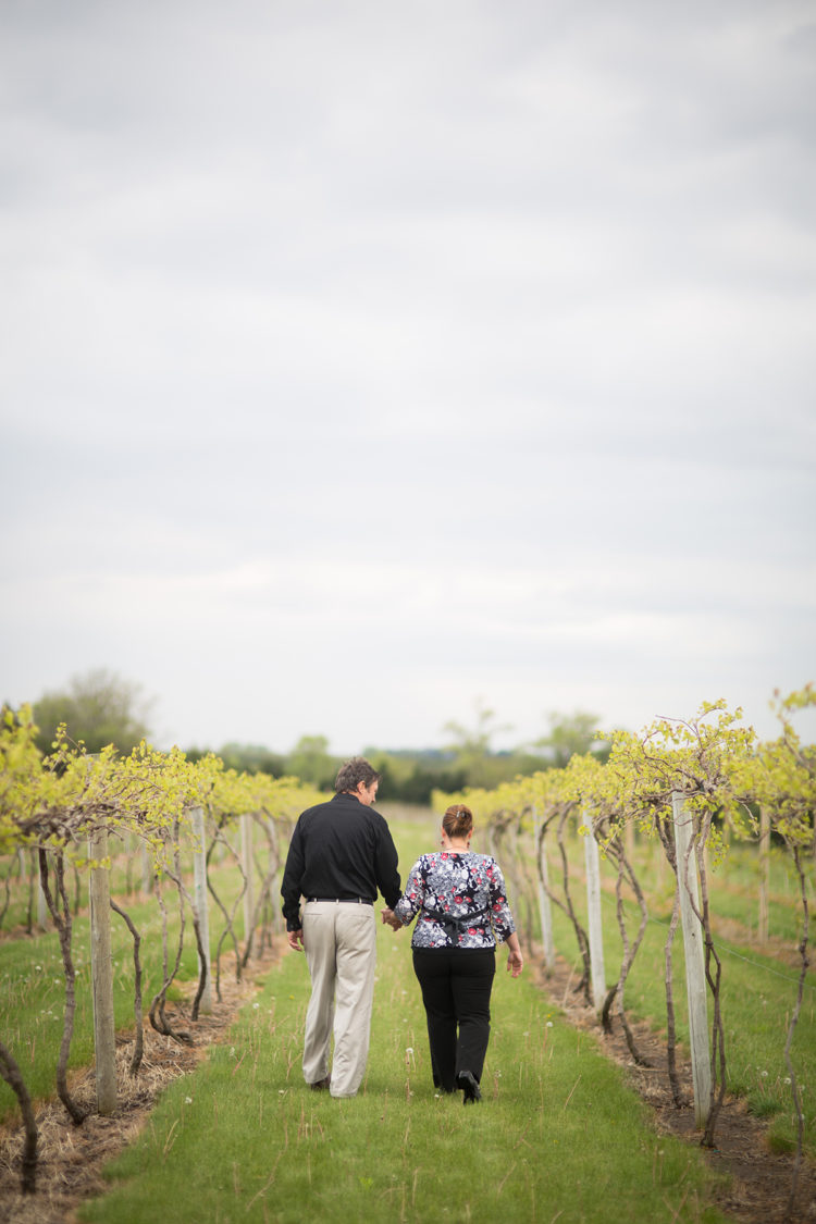 man and woman walking in a vineyard