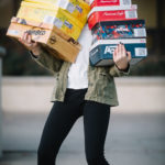 woman holding shoe boxes