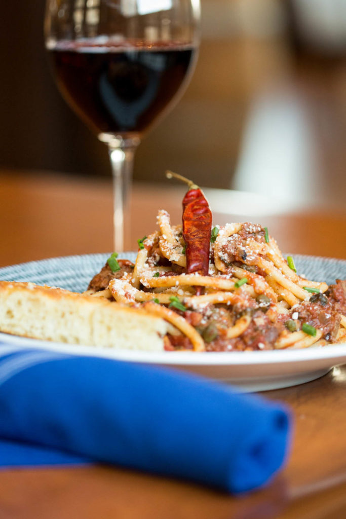 pasta dinner with glass of wine