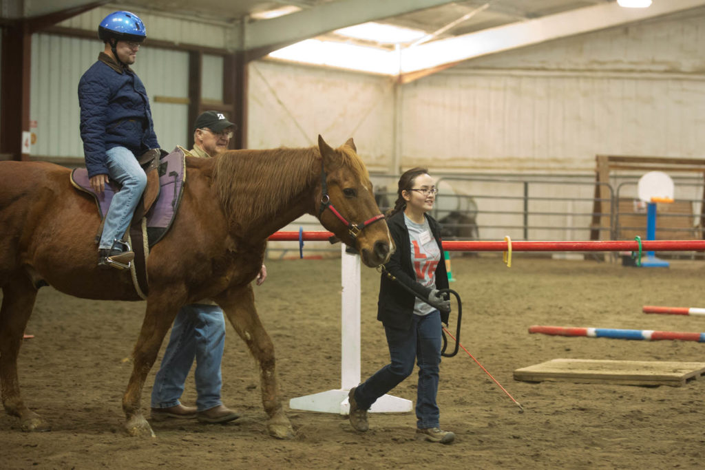 woman, man, and a horse