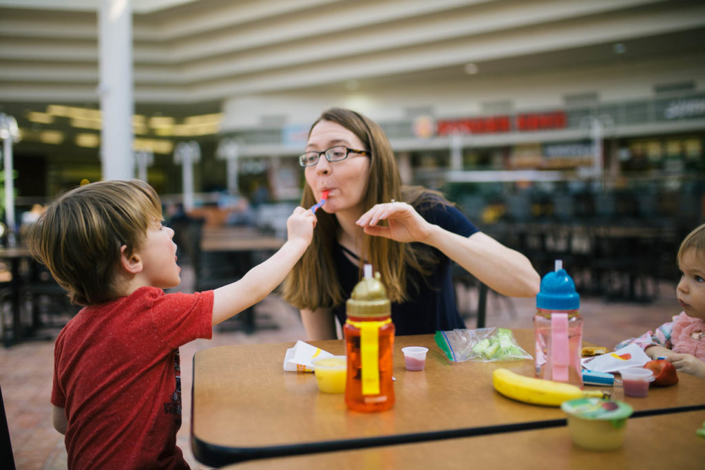 mom with kids at school lunch table