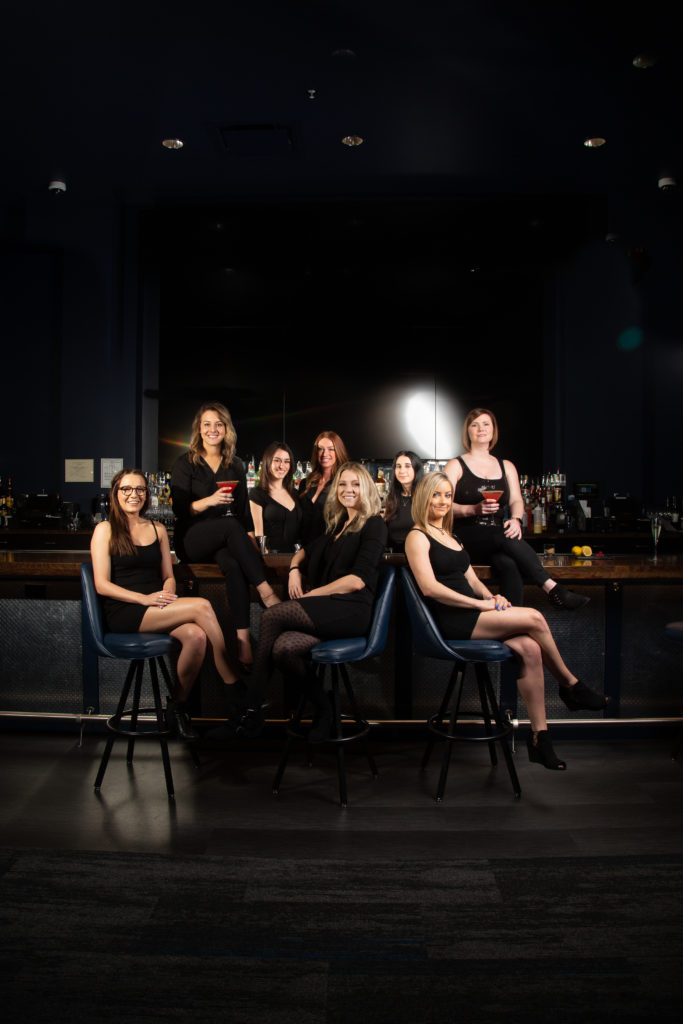 women at a bar with cocktails