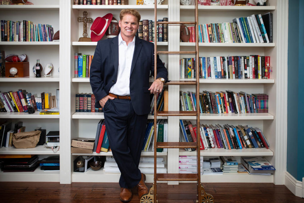 man in front of book shelves