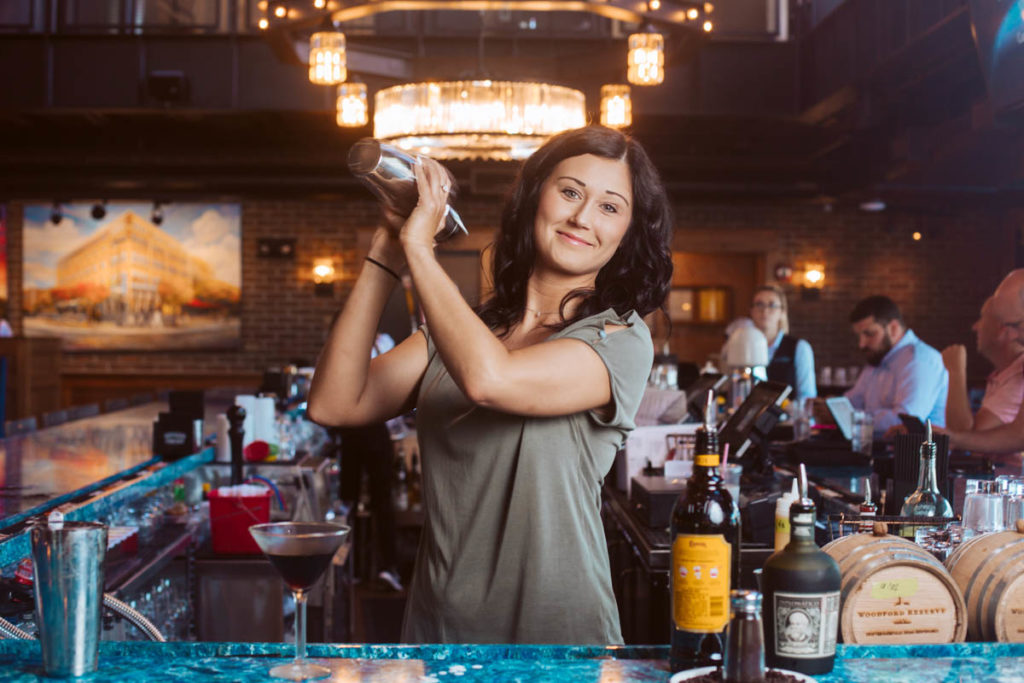 woman bartender shaking cocktail