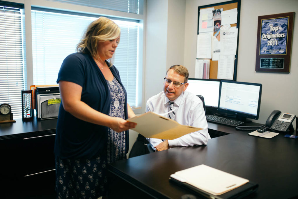 man and woman working in office