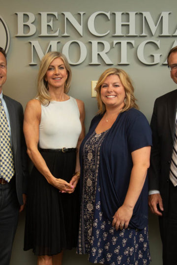 people standing by company logo