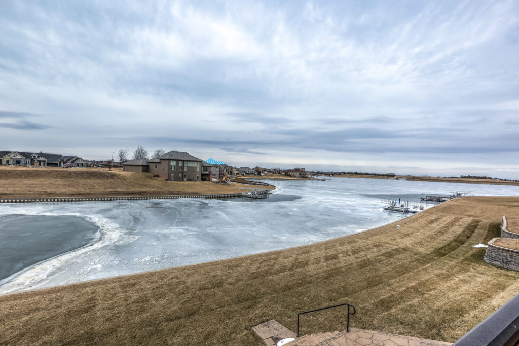 home at the edge of frozen lake