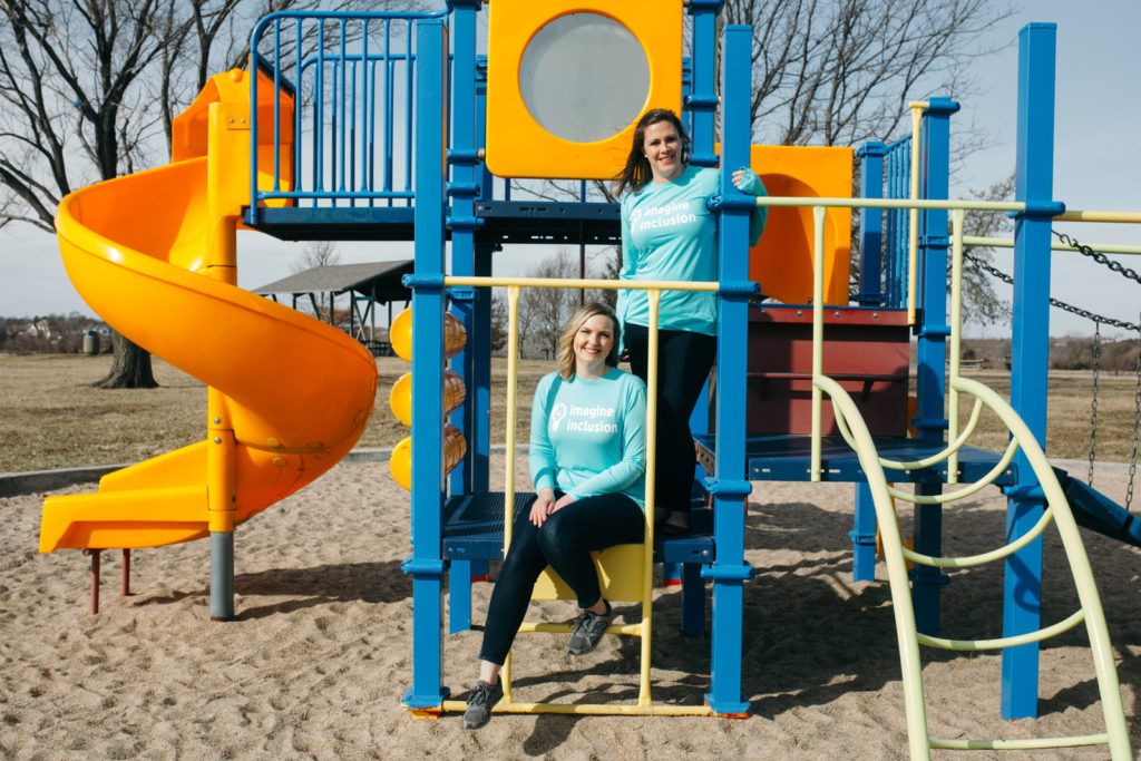 two woman on playground equipment