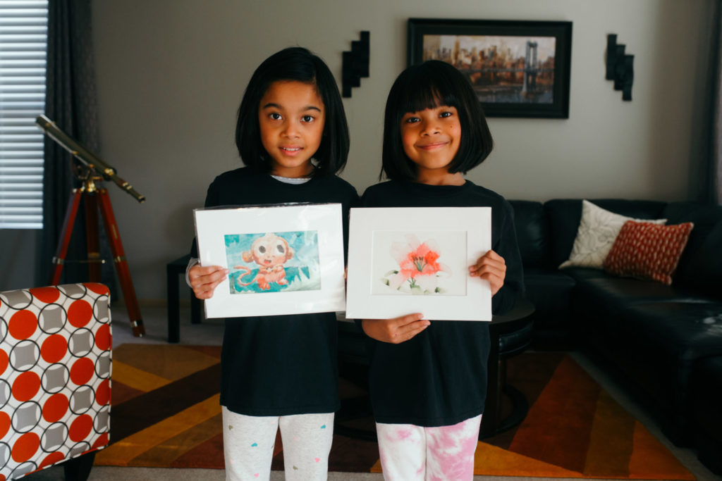 two kids with their paintings