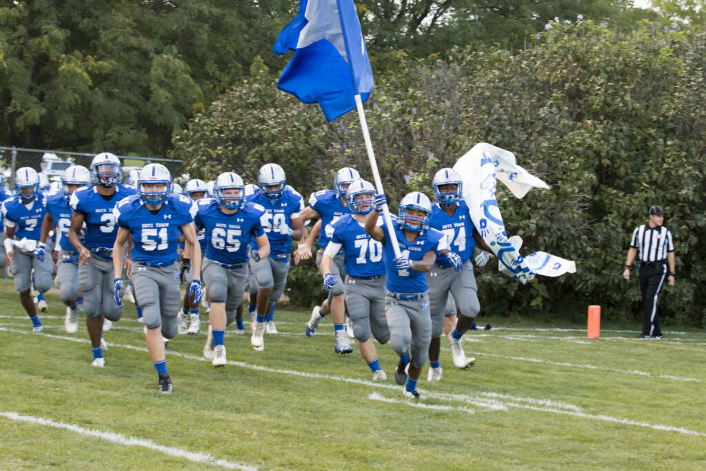 football team coming out on field