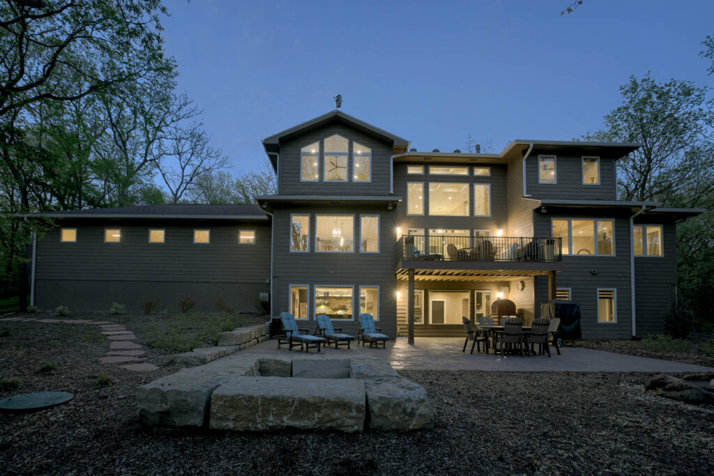 back of house at night with patio