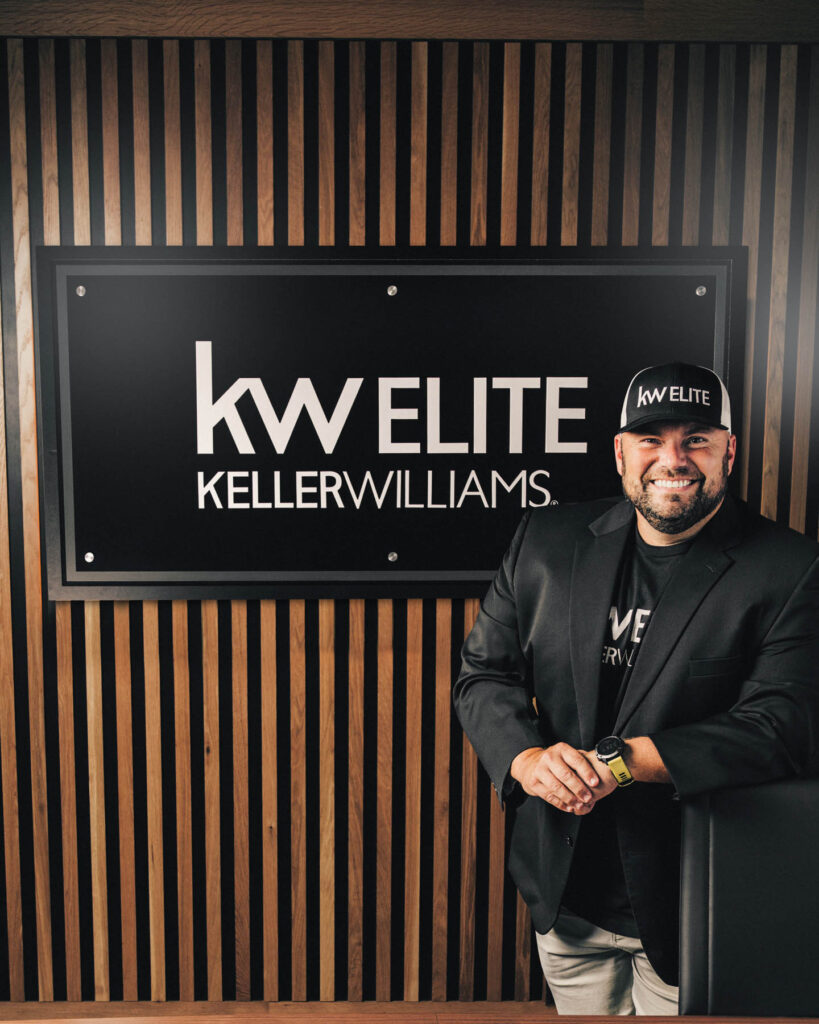 man with company logo sign