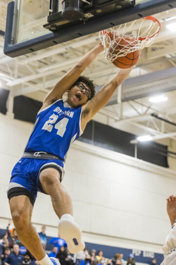 boy dunking basketball