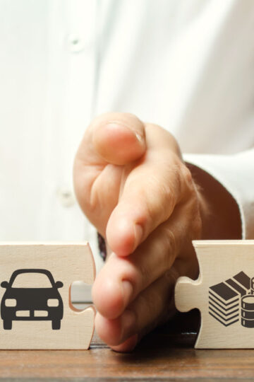 man's hand with wooden puzzle
